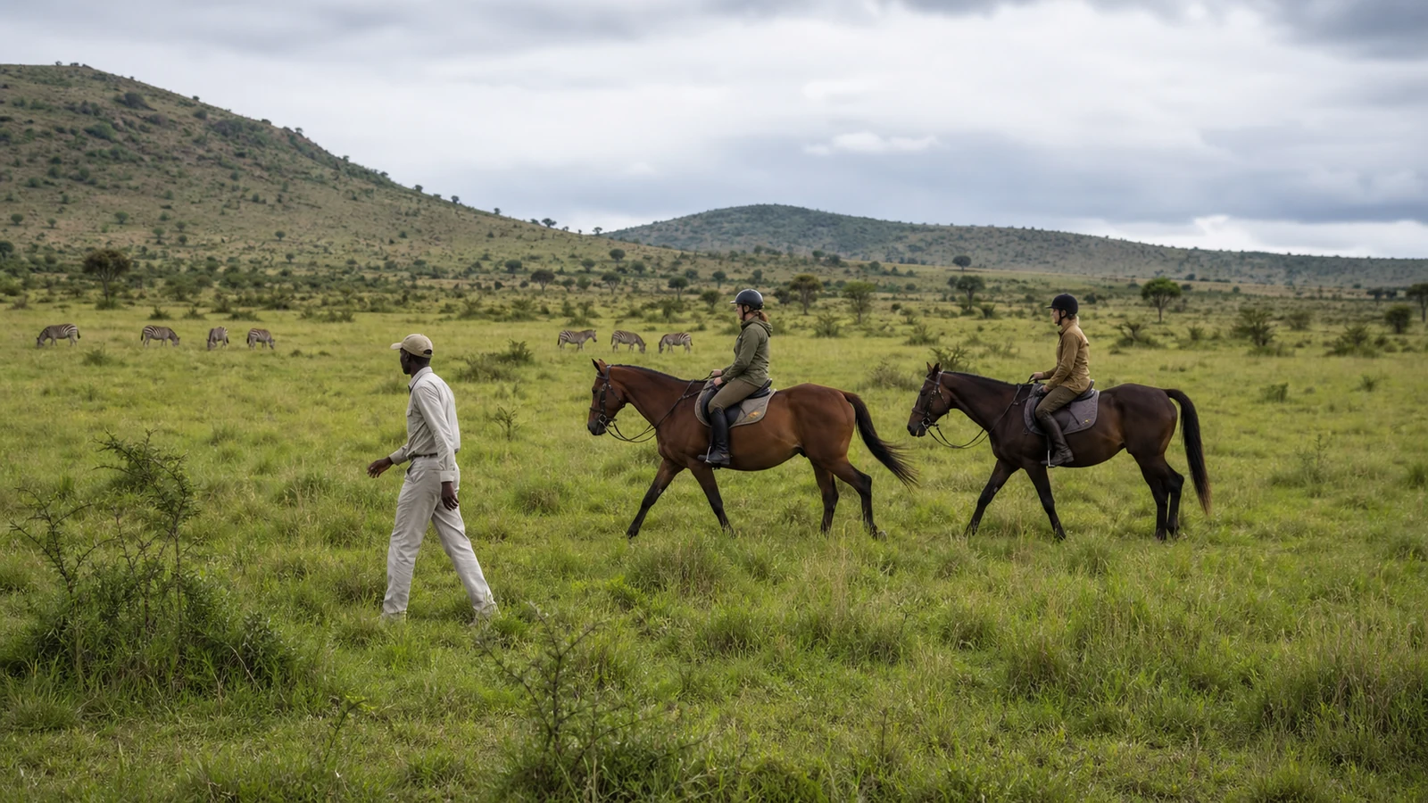 Riders crossing open grassland on a Chyulu Hills horseback safari