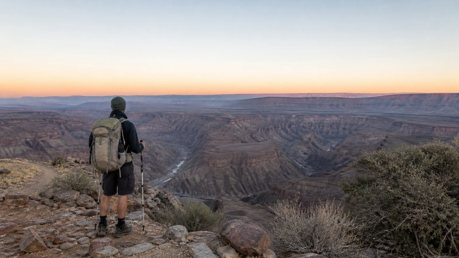 Hiker looking across Fish River Canyon from a marked viewpoint