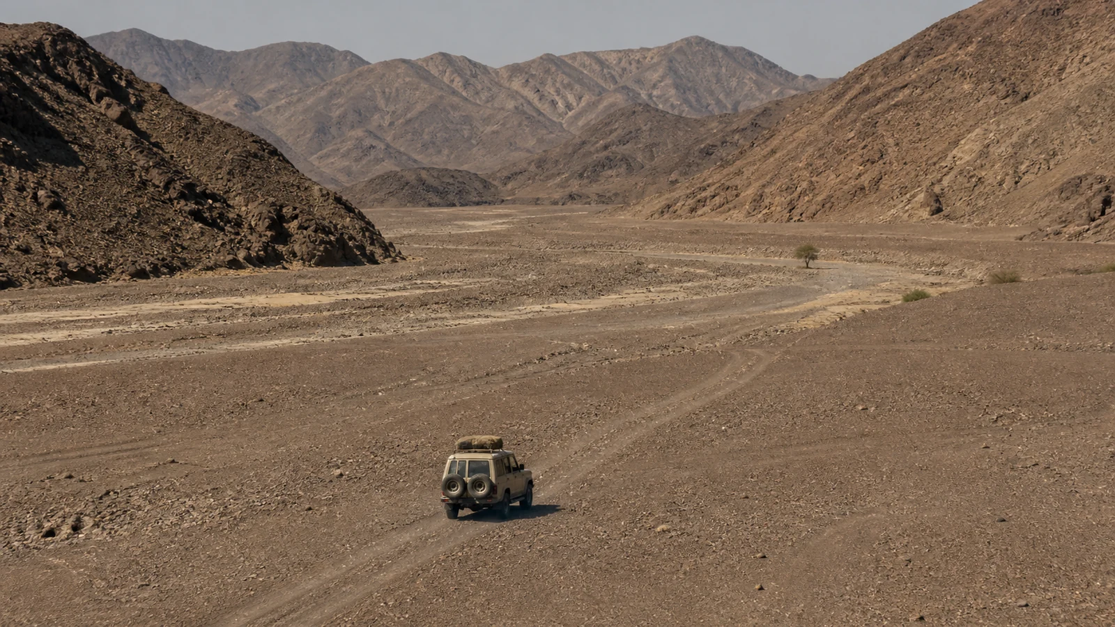 Safari vehicle following a remote riverbed track in Kaokoland